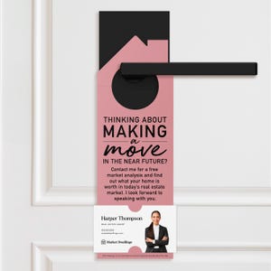 a pink door hanger with a black handle