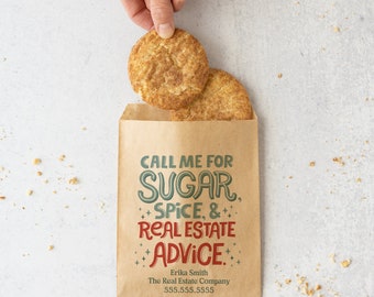 May include: A brown paper bag with the text "CALL ME FOR SUGAR, SPICE, & REAL ESTATE ADVICE."  The bag also includes the name "Erika Smith", "The Real Estate Company", and the phone number "555.555.5555".  Two cinnamon sugar cookies are on top of the bag.
