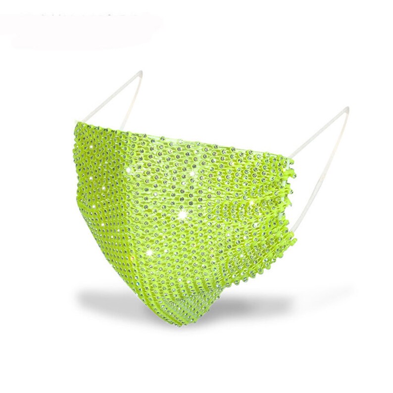 May include: A bright green face mask covered in rhinestones. The mask has white elastic straps.
