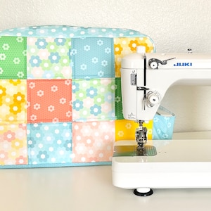 May include: A handcrafted wooden sign, painted white with a distressed finish and a black border, bearing the text "Welcome to our home" in a handwritten font. Designed for wall hanging.