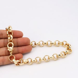 May include: A gold chain necklace with a textured, hammered finish. The chain is made of round links and has a lobster claw clasp.