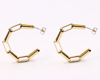 May include: Gold hoop earrings with a linked chain design.