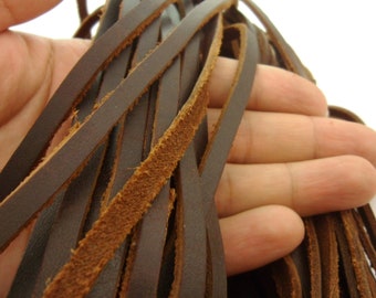 May include: A bundle of brown leather cords, showing the texture and detail of the leather.