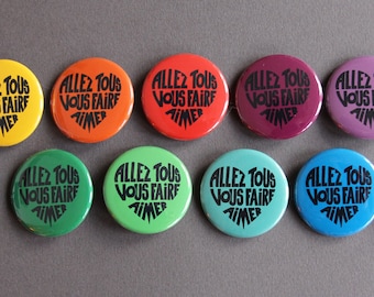 “Let us all love you” badge, black calligram on a color background of your choice, 38 mm diameter