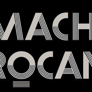 May include: A black rectangular sign with the text "LA MACHINE &Agrave; BROCANTES" in a stylized, art deco font. The text is in light gray, with the words stacked vertically.