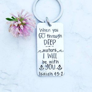 May include: Silver keychain with the text "When you go through deep waters, I will be with you. Isaiah 43:2"