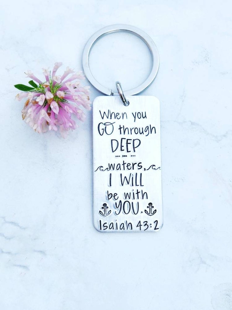 May include: Silver keychain with the text "When you go through deep waters, I will be with you. Isaiah 43:2"