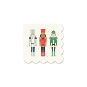 May include: Three nutcracker figurines stand in a row. The nutcracker on the left is wearing a blue and white uniform with a gold crown. The middle nutcracker is wearing a red and gold uniform with a gold crown. The nutcracker on the right is wearing a green and gold uniform with a gold crown.