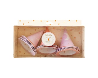 May include: A set of three pink witch hats with a crescent moon design, packaged in a clear box. The hats have a light pink color with a darker pink trim and a white interior. The box has a sticker that says "My Mind's Eye Best Witches".