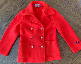 May include: A bright red double-breasted peacoat with gold buttons and a rainbow patch on the sleeve.