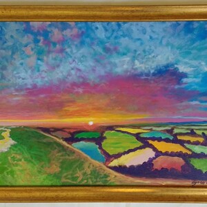 May include: A painting depicting a colourful sunset over a field of green, yellow, and pink patches. The sky is a vibrant mix of pink, blue, and purple with white clouds. The sun is setting in the distance, casting a warm glow over the landscape.
