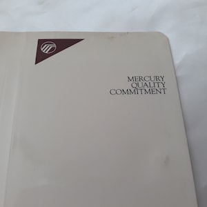 May include: A white folder with a brown Mercury logo and the text "Mercury Quality Commitment".