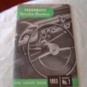 May include: A vintage black and white photo of a car's dashboard and steering wheel. The image is from a 1953 Fordomatic Driving Manual, issue number 7.