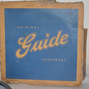 May include: A vintage cardboard box with a blue background and the text "ORIGINAL Guide EQUIPMENT" in gold lettering. The box has a handwritten number "42-48" on the top.