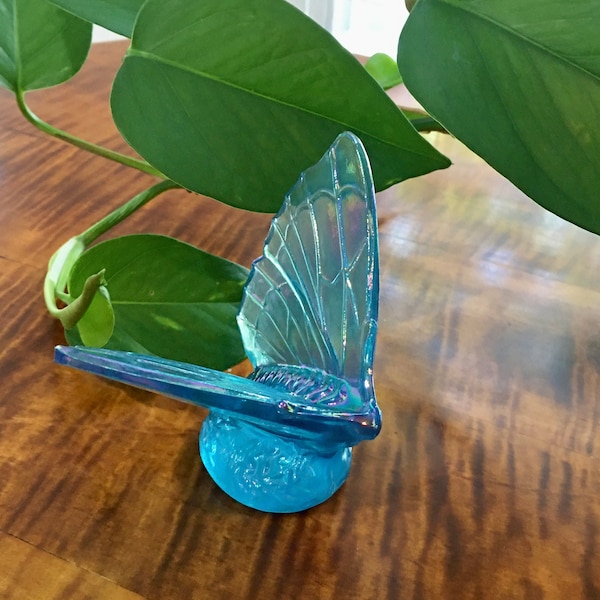 Fenton iridescent blue butterfly figurine paperweight. butterfly with wings spread, flowers at base. stamped marked. hand blown art glass