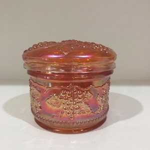 Marigold carnival glass trinket powder box with grapes leaves design. Dugan Glass Co Cable and gauge covered dish