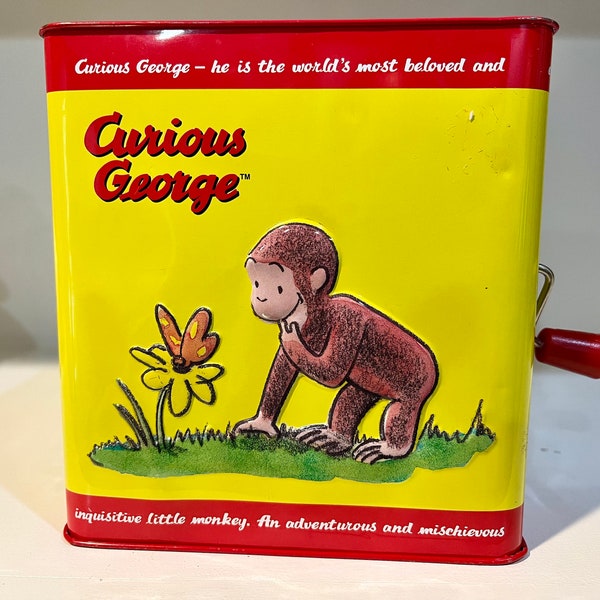 Curious George Schylling jack in the box toy. Tin Curious George monkey jack-in-the-box