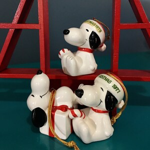 Snoopy Ornament. Snoopy with candy cane laying on gift, Merry Christmas 1977, 1979 japan, korea.  United Feature Syndicate. sold separately