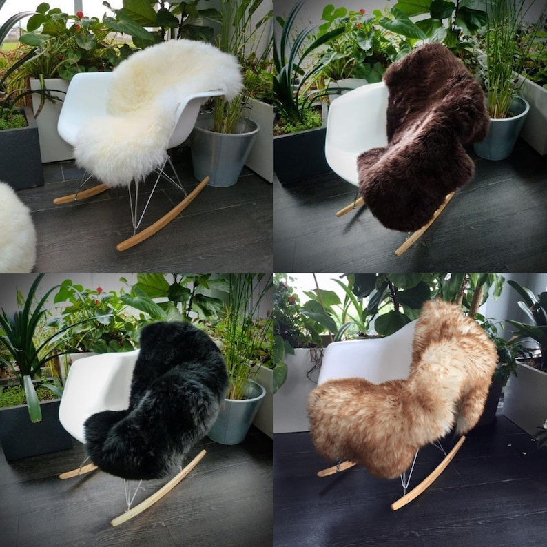 May include: Four white rocking chairs with different colored sheepskin rugs. The rugs are white, brown, black, and tan.