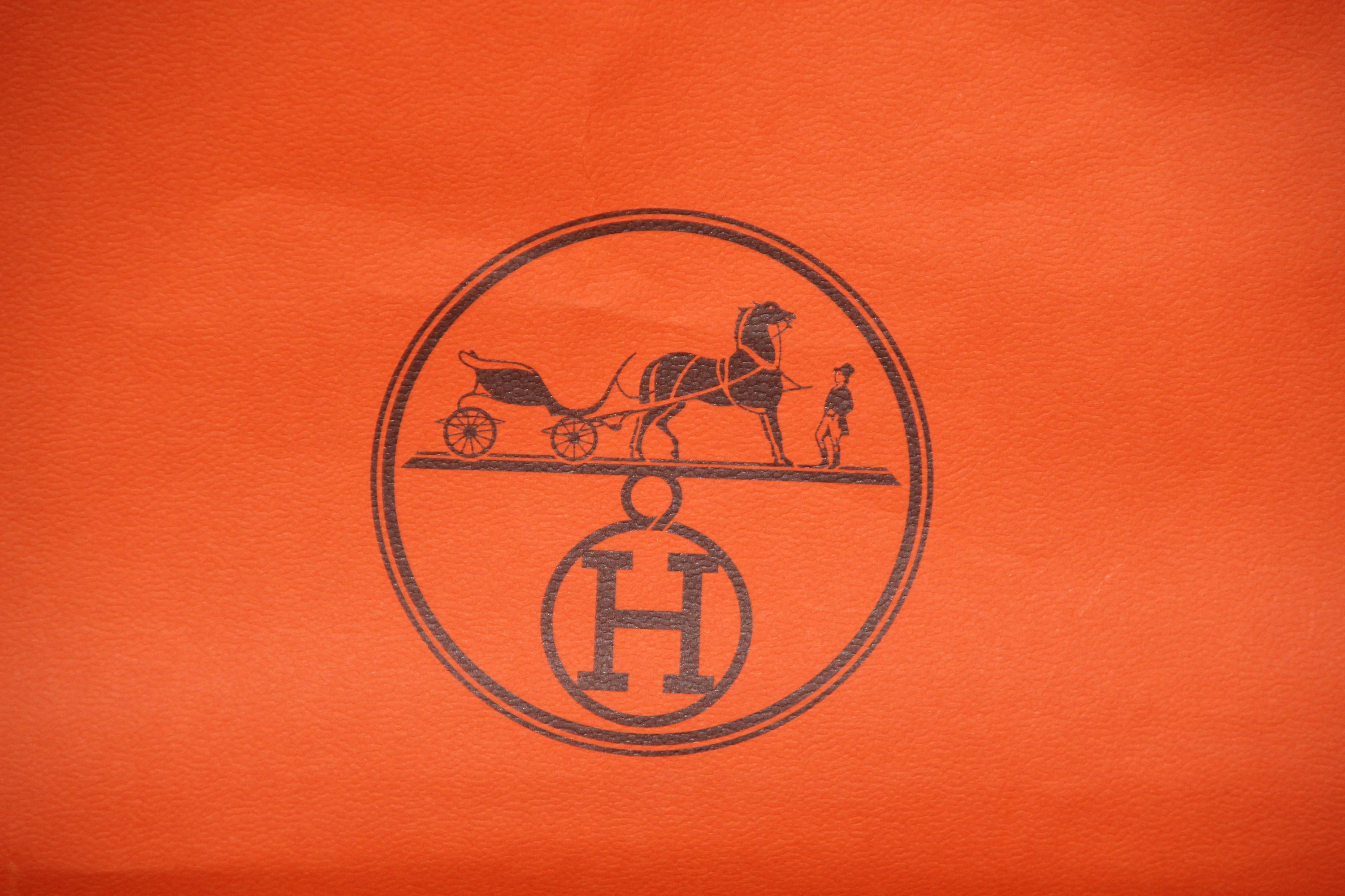 authentic hermes orange shopping bag with ribbon. approx 12x12x4.
