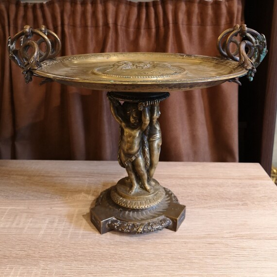 Gold pedestal centerpiece vase Angel decor Putti statue Mythology scenery