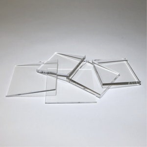 May include: A set of five clear acrylic squares of various sizes. The squares are stacked on top of each other.