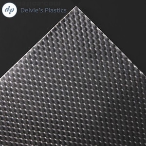 May include: A sheet of clear plastic with a textured surface. The texture is a repeating pattern of small, raised circles.