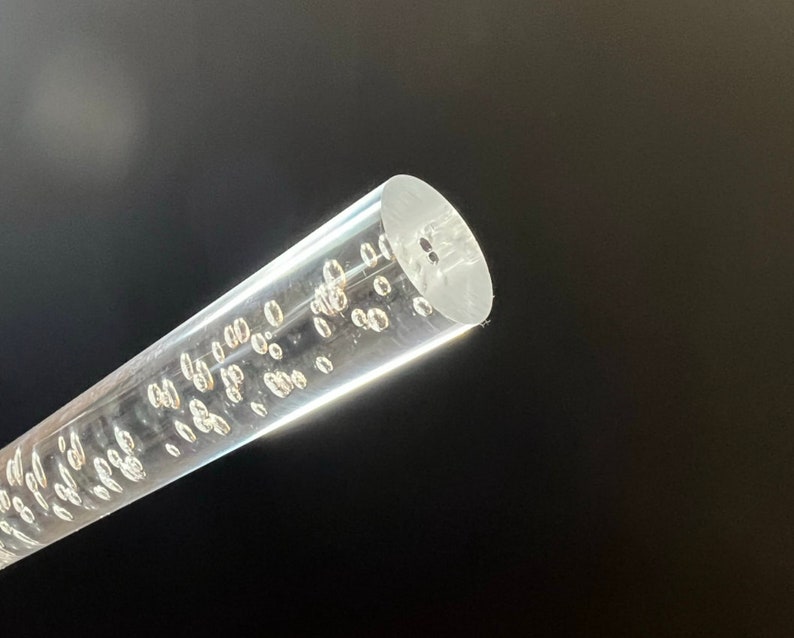 May include: A clear acrylic rod with small air bubbles throughout. The rod is about 1/2 inch in diameter.