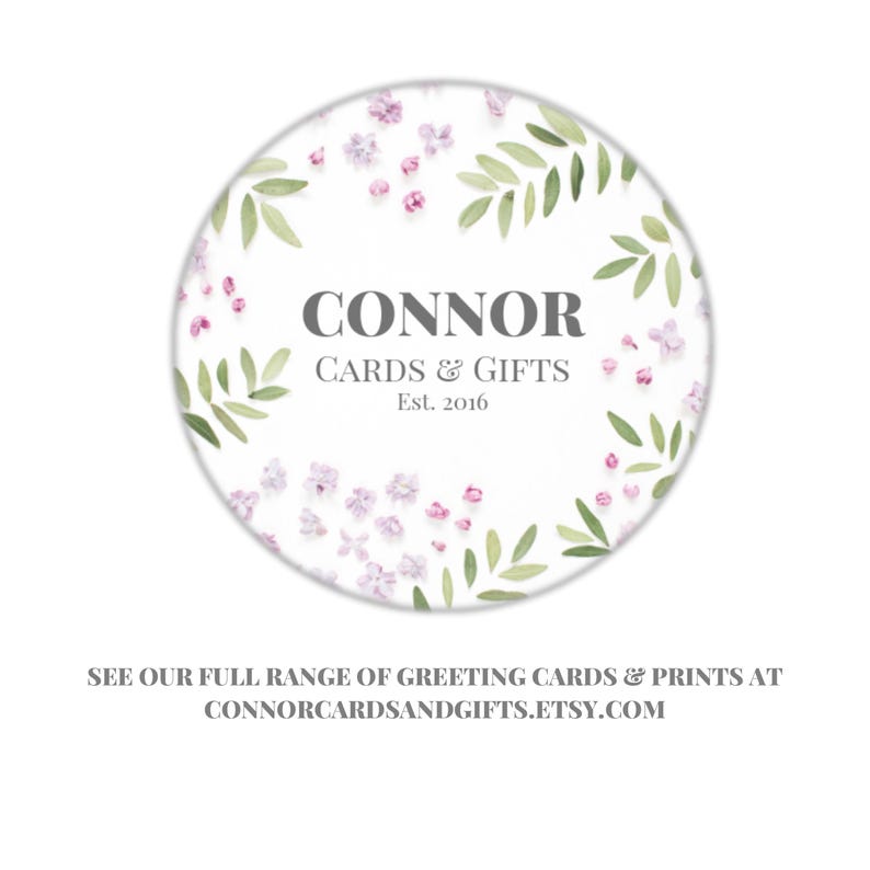 May include: A white circle with a floral design featuring green leaves and pink flowers. The text "CONNOR CARDS & GIFTS Est. 2016" is in the center of the circle.