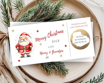 May include: A rectangular Christmas gift ticket featuring a watercolour illustration of Santa Claus, red text reading Merry Christmas, and the names Lucy, Nanny, and Grandpa. A gold scratch-off circle reveals the text Tickets to Matilda the Musical.