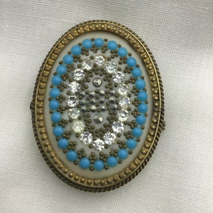 Vintage 1940s brass and gold tone cream celluloid and faux turquoise blue glass, cut steel & white paste detailed oval brooch Trombone clasp