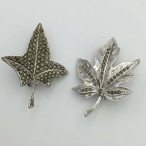 2 vintage 1940s to 1950s silver tone and Marcasite leaf brooches. In good condition and stones complete. Can sell separately