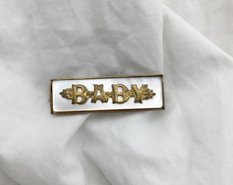 Antique baby name brooch 1910s to 1920s Mother of pearl shell and gold plate on brass rectangle shaped bar brooch. Size 3.5cm x 11mm wide