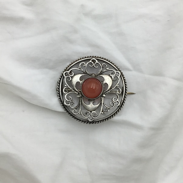 Antique Victorian arts and crafts C1890 Silver and orange brown agate ornate floral round circle brooch. Size 3cm. Good condition