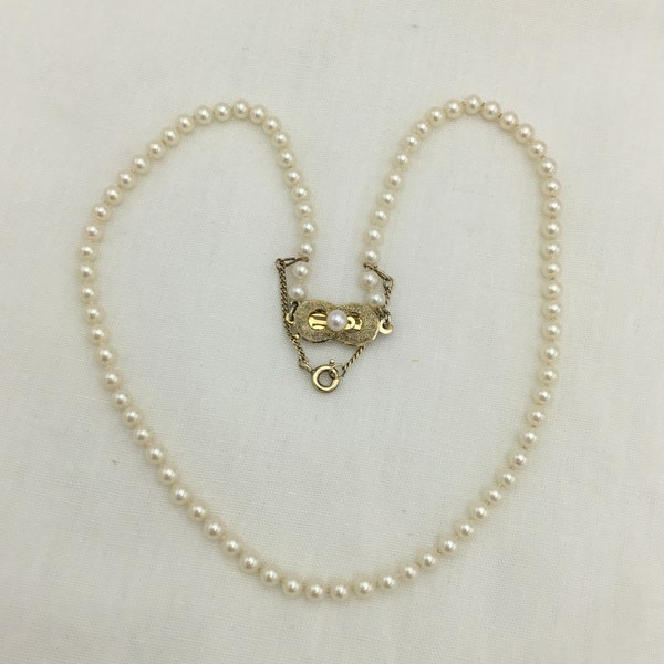 Good quality costume pearl necklace. Small pearl size 4.5mm. Gold on sterling silver pearl clasp. Length 15.5 inch or 39.5cm.