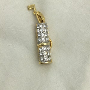 Vintage gold tone & white rhinestones golf clubs brooch. Size 5.2cm x 17mm widest. Good condition Signed but can’t make it out. C1980s 1990s