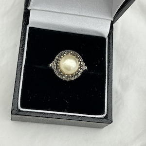 May include: A set of three ceramic mugs with a speckled, matte finish. The mugs are in shades of cream, light gray, and dark gray. Each mug has a simple, minimalist design, perfect for coffee or tea.