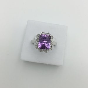 Second hand 9ct white gold amethyst gemstone rectangular ring. Nicely cut stone. Fancy edge setting With certificate Size N. US 7. Weight 4g