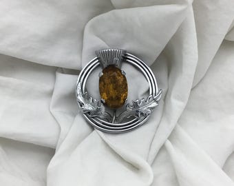 Broche vintage de la década de 1940 con forma de círculo y piedra de vidrio de topacio amarillo anaranjado celta con cardo escocés. Tamaño: 3,3 cm.