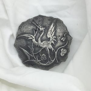 Vintage 1930s to 1940s silver plated crane or stork bird brooch. Detailed Art Deco design. Size 4.2cm. Has wear small pitting mark on front