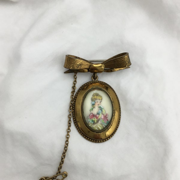 Vintage 1940s - 1950s Crinoline or Georgian pink Lady bow fob drop pendant brooch in good condition signed TLM for Thomas L Mott England.