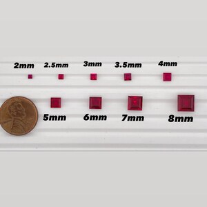 May include: Size comparison of red square-shaped gemstones, ranging from 2 mm to 8 mm. The gemstones are arranged in two rows on a white surface. A US penny is included for scale.