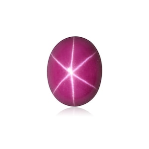 Puede incluir: Una piedra preciosa de rub&iacute; estrellado rosa con una estrella de seis puntas en el centro.