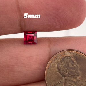 May include: A 5mm square red gemstone, shown next to a US penny for size comparison.