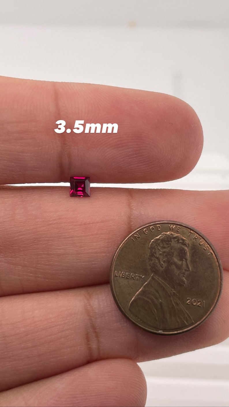 May include: A 3.5mm square red gemstone next to a US penny for size comparison.