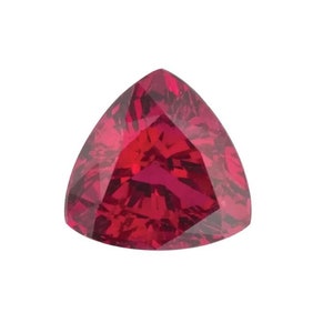 May include: A deep red triangular gemstone with a faceted cut.