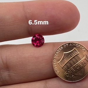 May include: A white ceramic mug with a black handle and the text "But First, Coffee" in a bold, black font. The mug is set against a neutral background, highlighting its simple design.