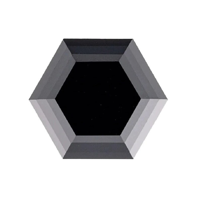 May include: A black hexagonal diamond with a faceted cut.