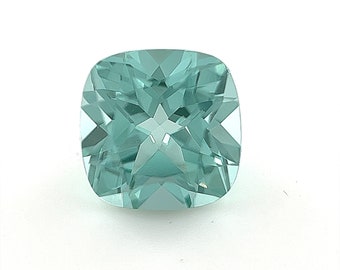 May include: A light blue cushion-cut gemstone with a star-shaped pattern inside.