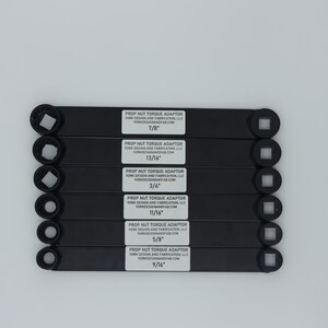 May include: A set of eight black prop nut torque adaptors with different sizes: 7/8", 13/16", 3/4", 11/16", 5/8", and 9/16".